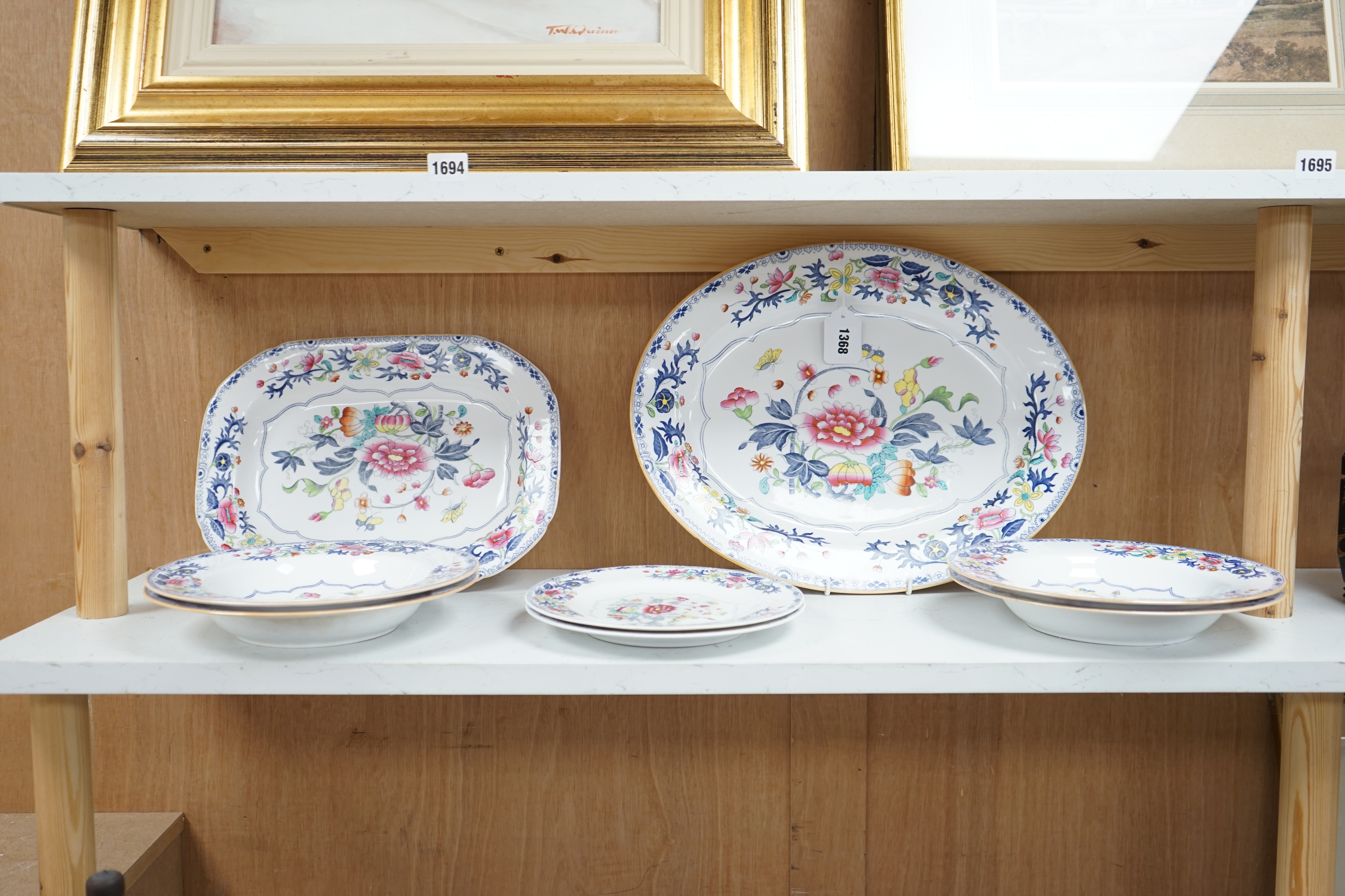 Spode Copeland dinner ware, comprising an oval and a rectangular meat dish and six plates, each painted with peonies and other flowers, largest 43cm wide (8). Condition - poor